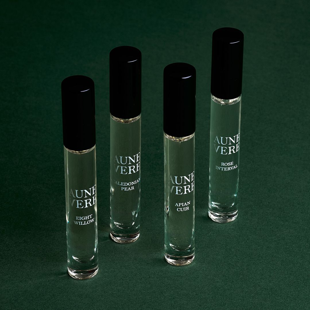 Four Aune Vere 10 ml bottles standing on green paper.