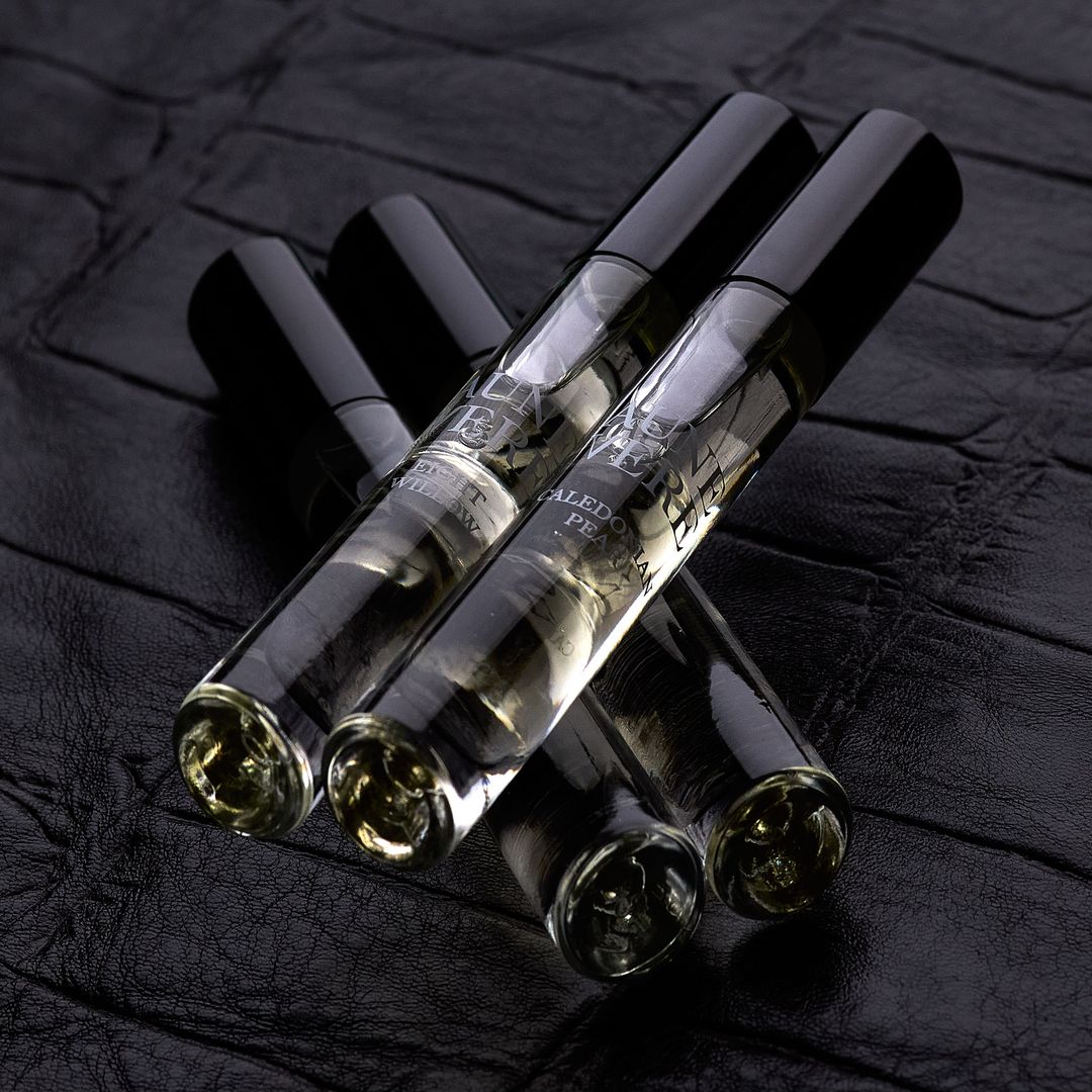 Four Aune Vere 10 ml bottles lying on black leather, Eight Willow and Caledonian Pear in the foreground.