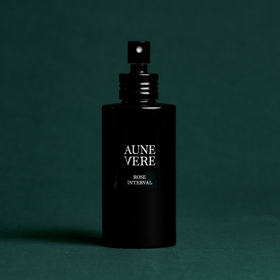 Rose Interval 100 ml bottle standing on green paper.