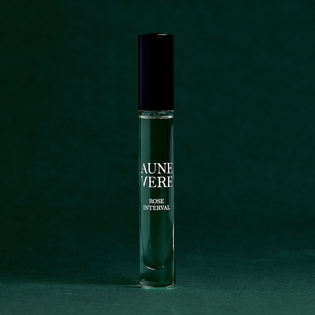 Rose Interval 10 ml bottle standing on green paper.